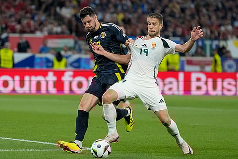 Scott McKenna and Barnabas Varga challenge for the ball
